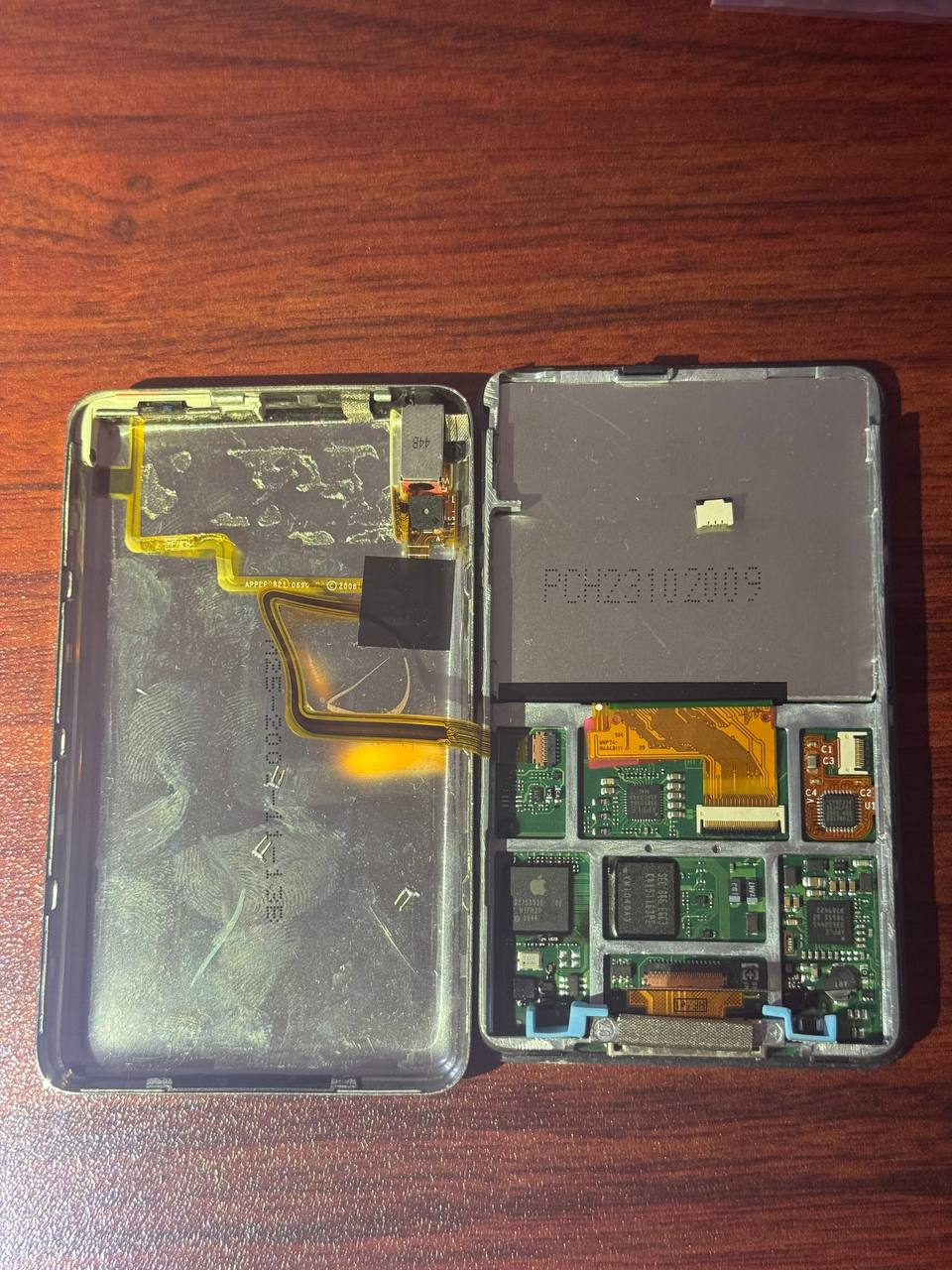 An iPod Classic opened without a disk or a battery.